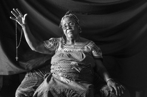 Maria, 57, sites the cross she holds in this photograph as the most important thing she brought with her into exile. It was given to her by the nuns in the hospital where she delivered her son before fleeing to DRC in 1962. Just nine days after the birth, soldiers came and killed her husband in front of her. Her eyes fill with tears describing the scene 50 years later. She and her children, one of which was only nine days old, immediately fled into the forrest where they lived off the land and drank rain water for seven and a half months before crossing into DRC. She says that if she had to flee again, she would grab the cross first. “With it I am at peace. If I didn’t have this cross, I wouldn’t be here today. It saved my life and the lives of my children.”