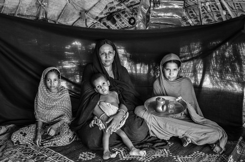 Malian refugee Mamma Wallet Bona, 40, center, and her children, pose for a portrait inside their shelter at Damba refugee camp in Burkina Faso on March 11, 2013. Agade’s wife Mamma brought the family tea set. “The life of the Tuareg is tea,” she says. “It gives us energy, even when there is no food.” During the journey, she kept it next to her in a small sack, slung over the back of the donkey she and three of her children rode to escape. Drinking tea is the first thing that Mamma does each morning, a ritual that is repeated throughout the day. “Tea is the tradition of our ancestors. If we don’t follow that tradition, we are no longer Tuareg.”